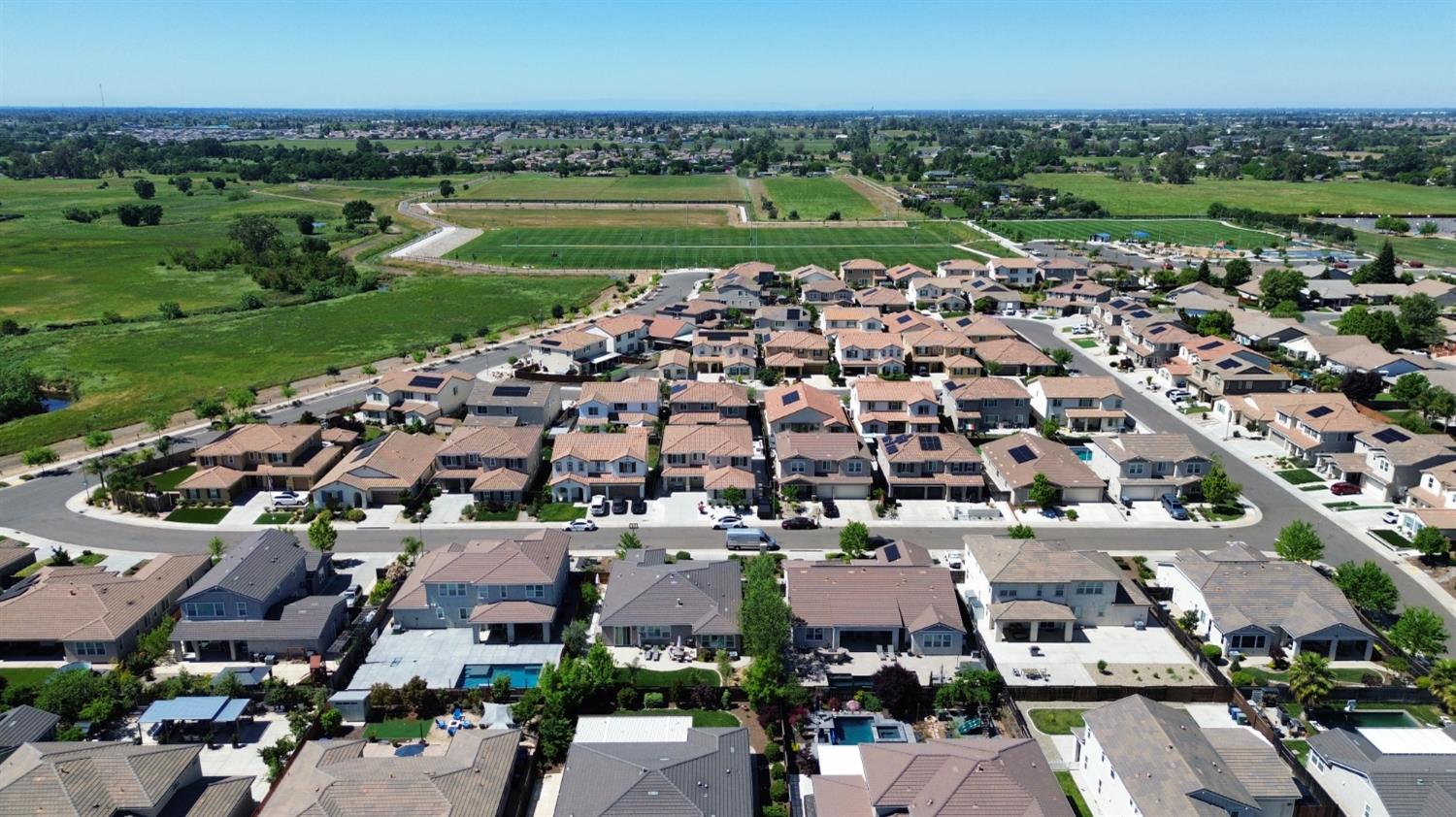 8026 Prairie Hawk Way Sacramento, CA 95829 - Photo 3 of 30 an aerial view of a city with lots of residential buildings and mountain view in back