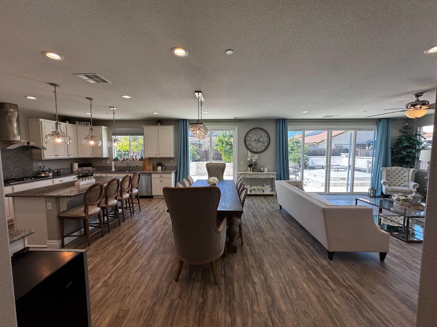8026 Prairie Hawk Way Sacramento, CA 95829 - Photo 10 of 30 a living room with lots of furniture wooden floor and a large window