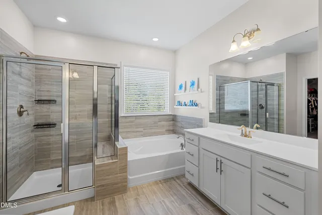 a bathroom with a tub sink and mirror