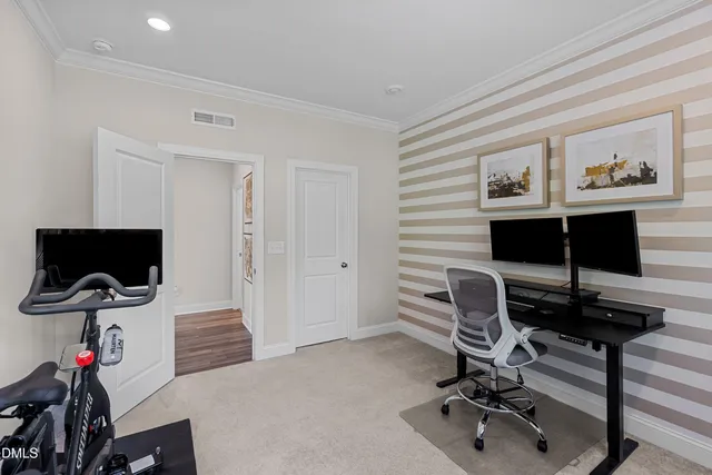 a view of a livingroom with workspace and a window