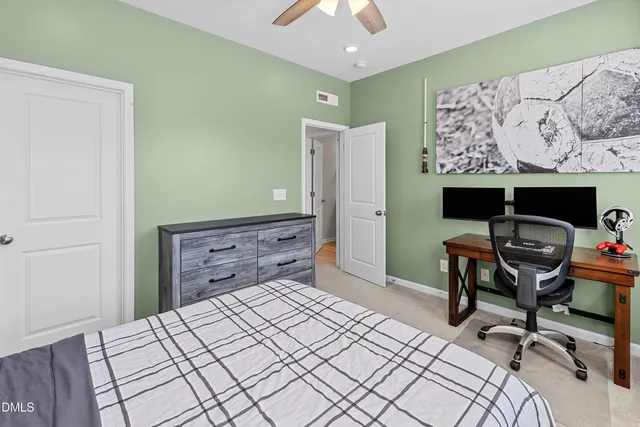 a bedroom with a bed and a desk