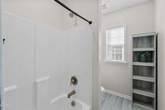 a spacious bathroom with a granite countertop sink mirror and double
