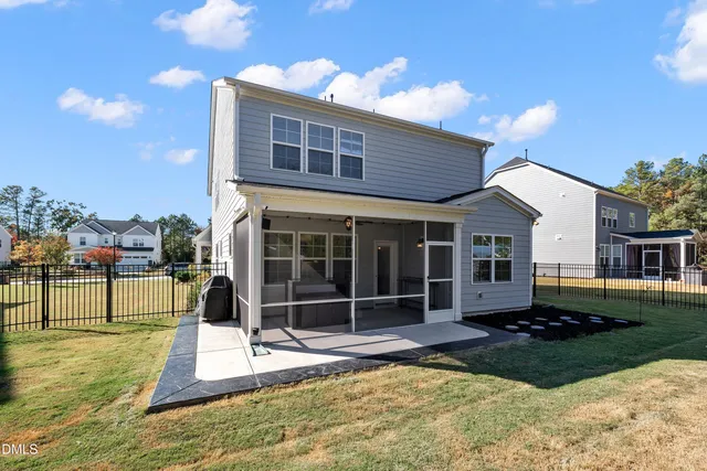 a view of house with backyard and deck