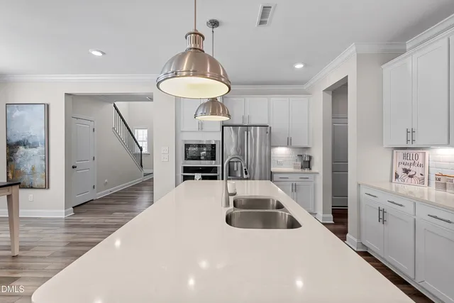 a large kitchen with stainless steel appliances granite countertop a sink and a stove