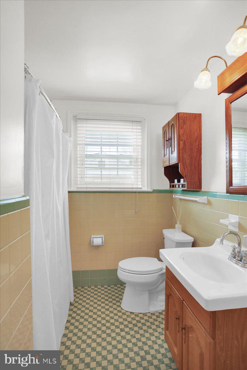 3812 Reiff Place Reading, PA 19606 - Photo 15 of 38 a bathroom with a sink a toilet and mirror