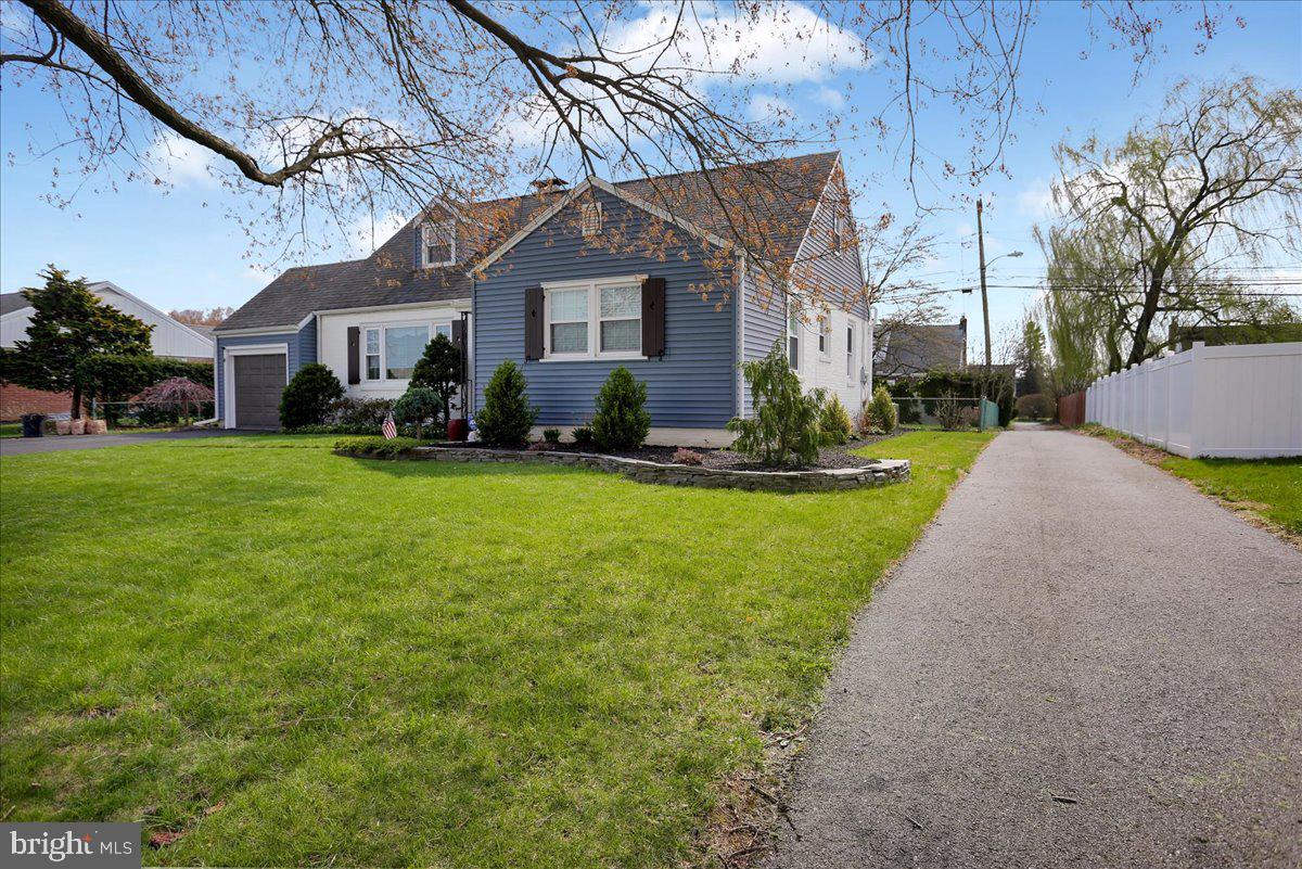 3812 Reiff Place Reading, PA 19606 - Photo 33 of 38 a front view of a house with a yard and trees