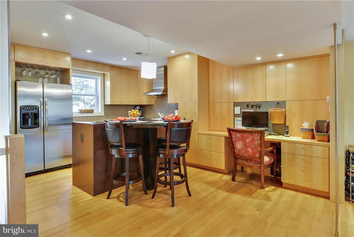 3873 Chain Bridge Road Fairfax, VA 22030 - Photo 2 of 29 a kitchen with stainless steel appliances granite countertop a table and chairs in it