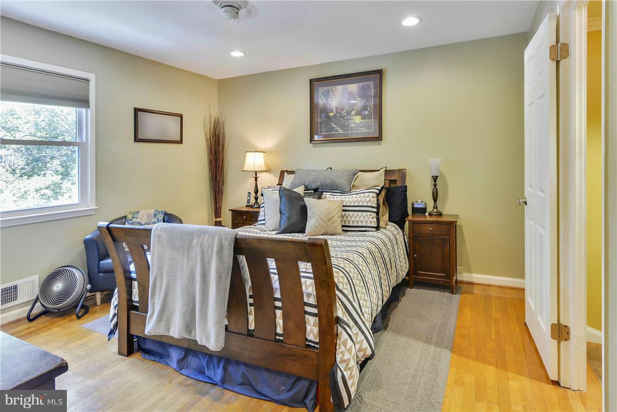3873 Chain Bridge Road Fairfax, VA 22030 - Photo 14 of 29 a bedroom with a bed and wooden floor