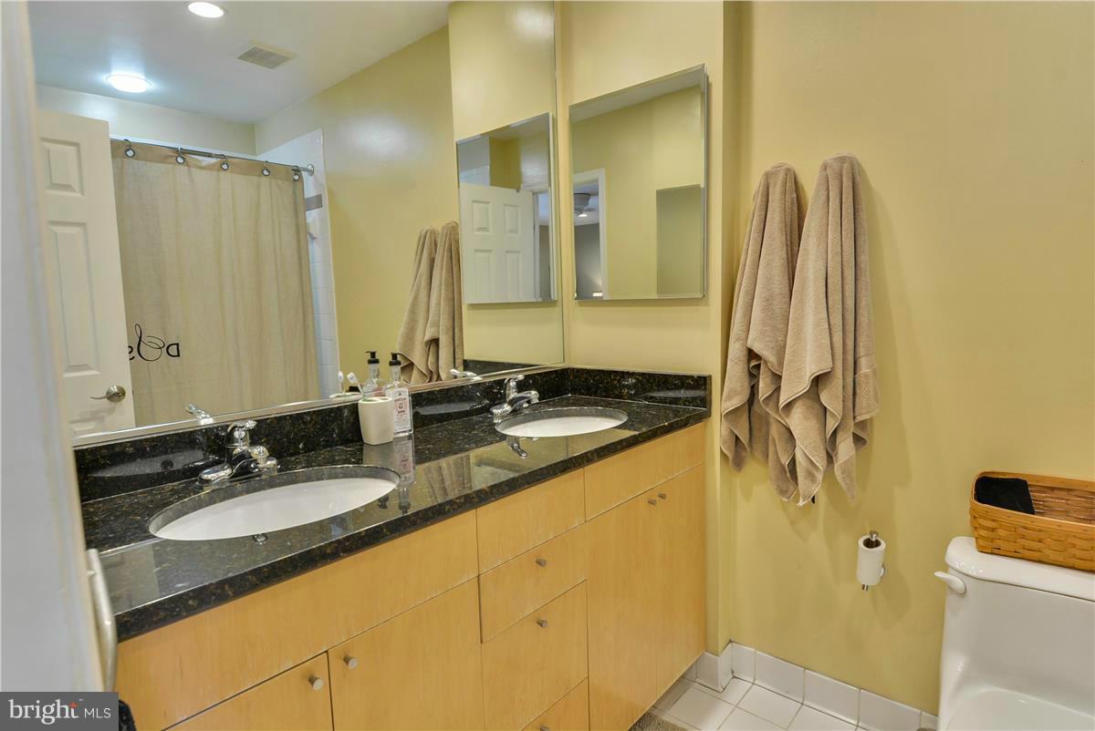 3873 Chain Bridge Road Fairfax, VA 22030 - Photo 16 of 29 a bathroom with a granite countertop sink and a mirror