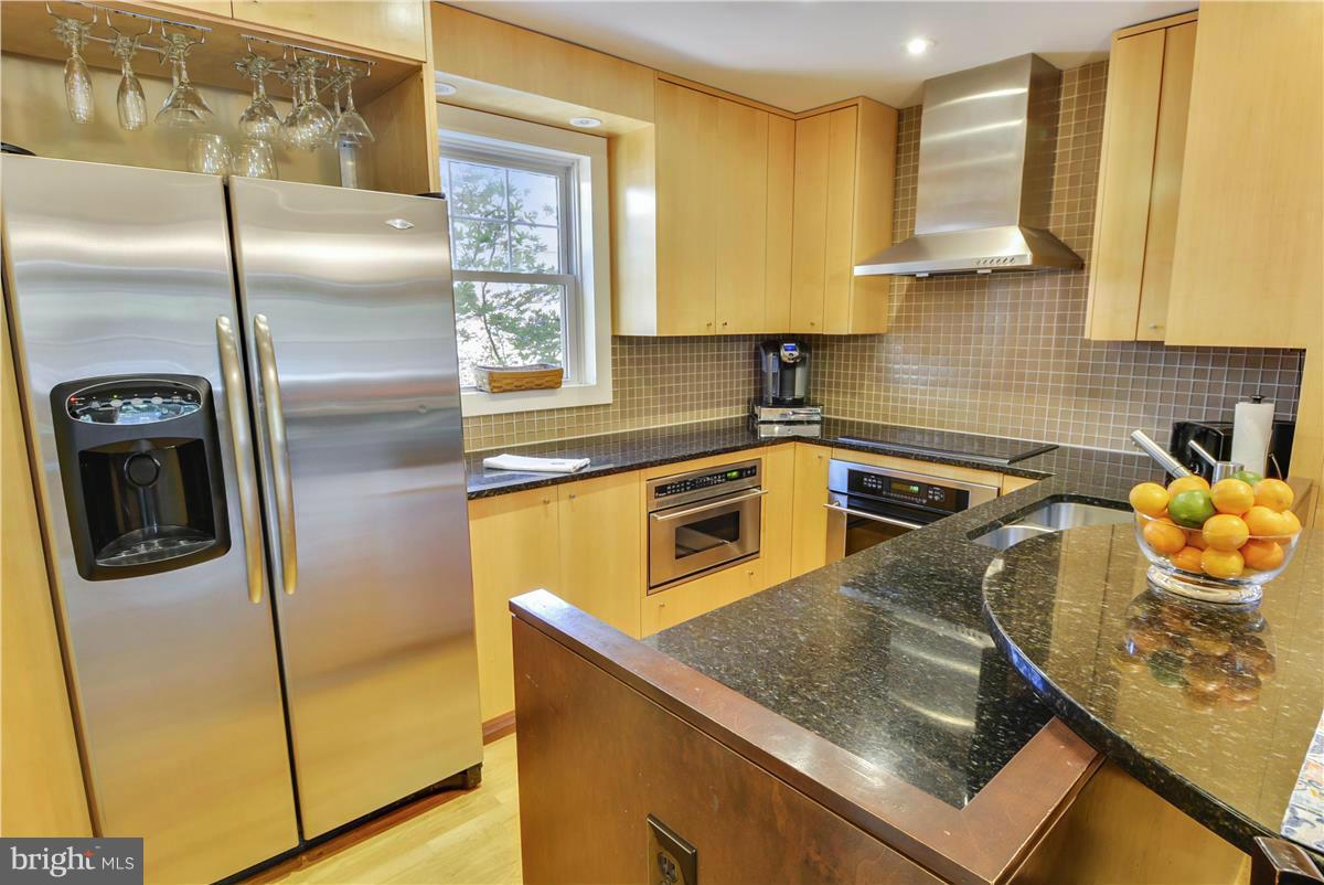 3873 Chain Bridge Road Fairfax, VA 22030 - Photo 3 of 29 a kitchen with stainless steel appliances granite countertop a sink a stove and a refrigerator
