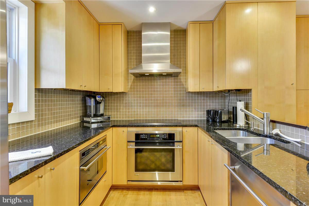 3873 Chain Bridge Road Fairfax, VA 22030 - Photo 4 of 29 a kitchen with granite countertop a sink a stove and cabinets