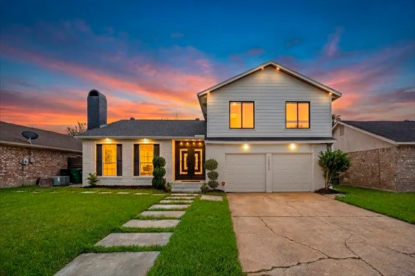 a front view of a house with a yard and garage