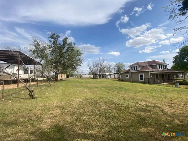 a view of a house with a yard