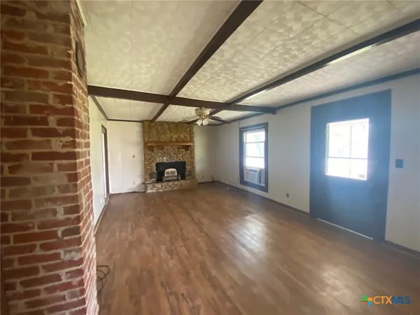 a view of empty room with a fireplace