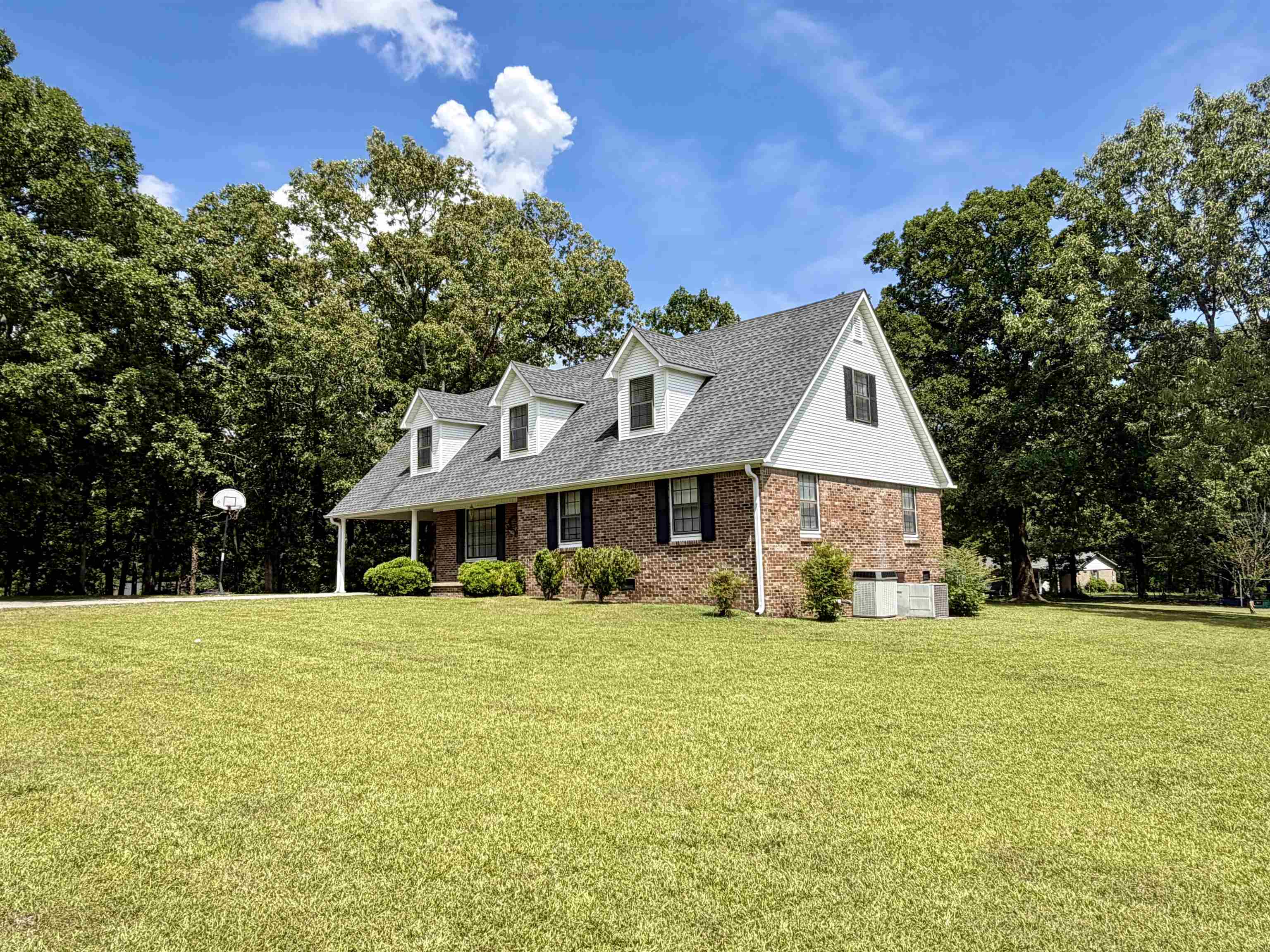 142 Treece Street Selmer, TN 38375 - Photo 31 of 36 Brick and siding exterior residence featuring a gabled roofline with dormer windows