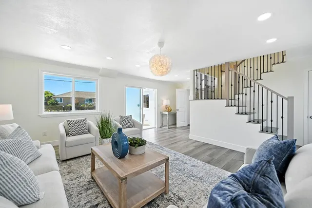 a living room with furniture and wooden floor
