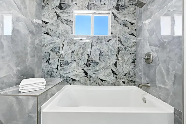 a bathroom with a bathtub and toilet