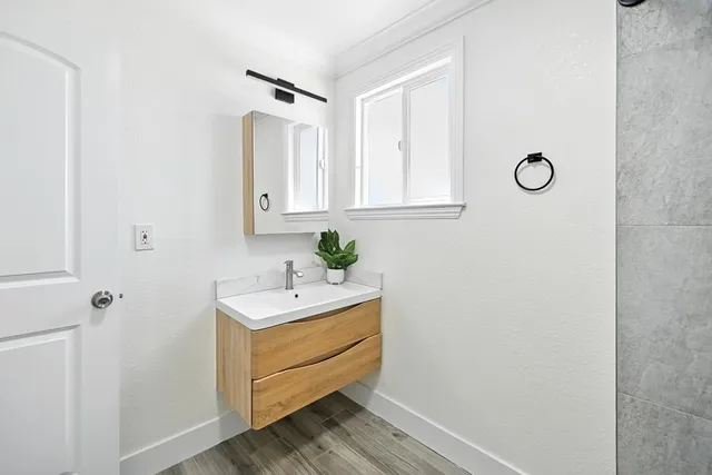 a bathroom with a toilet a sink and mirror