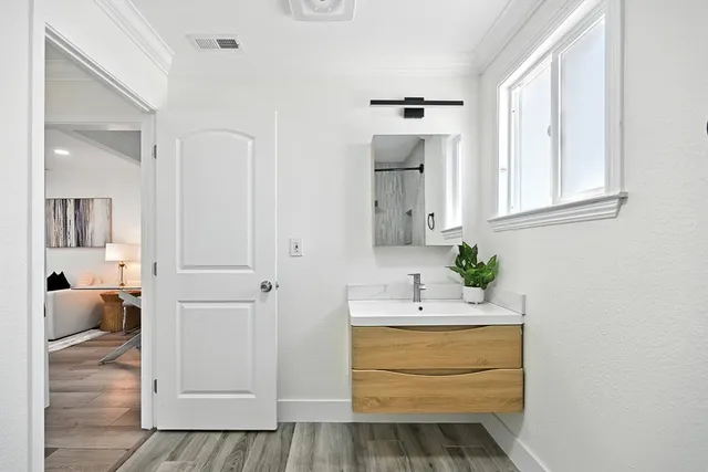 a bathroom with a sink vanity and mirror