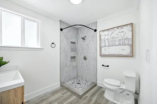 a bathroom with a toilet a sink and shower