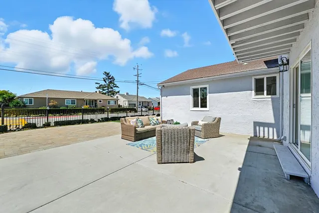 a swimming pool with outdoor seating and yard