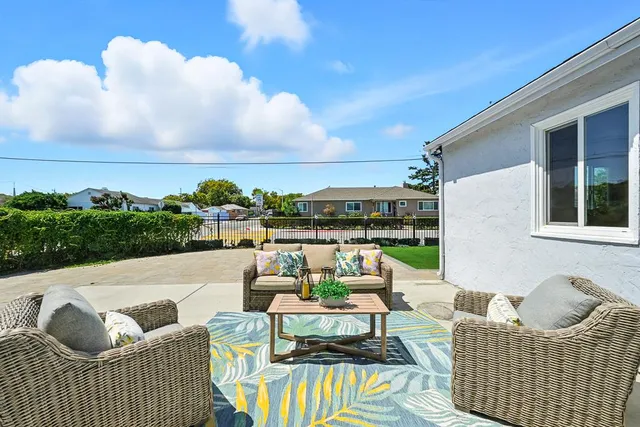 a view of a patio with couches and pool
