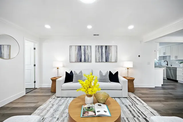 a living room with furniture and wooden floor