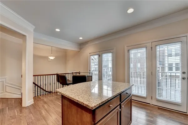 a dining hall with stainless steel appliances granite countertop a granite counter tops and wooden floors