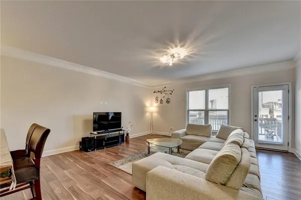 a living room with furniture a ceiling fan and a window