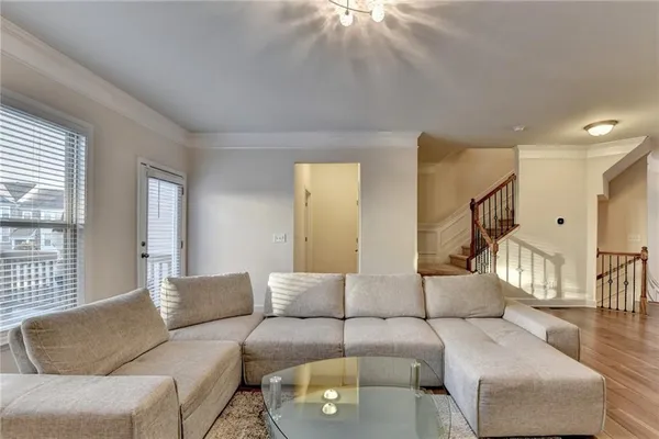a living room with furniture a dining table and a piano table