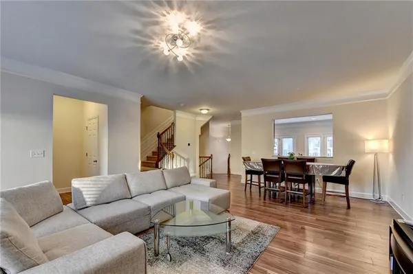 a living room with furniture a dining table and a fireplace