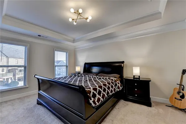 a bedroom with a bed and a chandelier