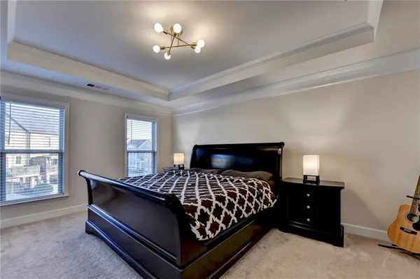 a bedroom with a bed and a lamp