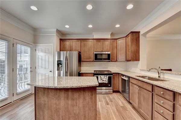 a kitchen with stainless steel appliances a sink stove and refrigerator