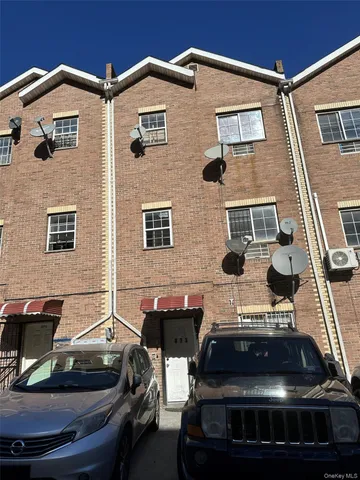 a front view of a house with parking space