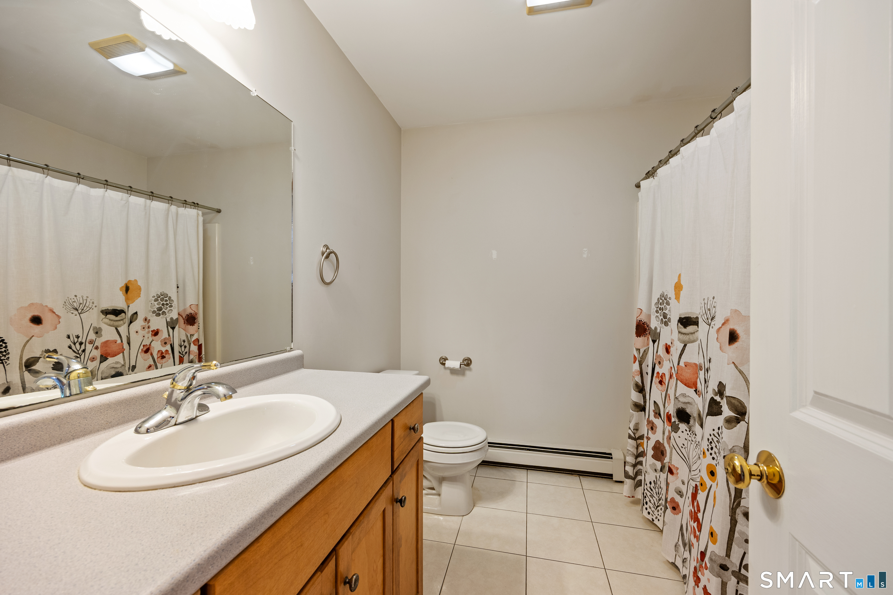 694 Millbrook Road Middletown, CT 06457 - Photo 11 of 34 a bathroom with a sink a toilet and shower curtain