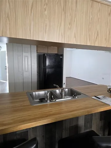 a view of an empty room with closet and wooden floor