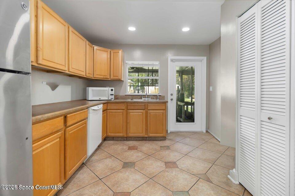 1280 Highway 1, Unit B Malabar, FL 32950 - Photo 18 of 26 a kitchen with granite countertop a sink a stove cabinets and entryway