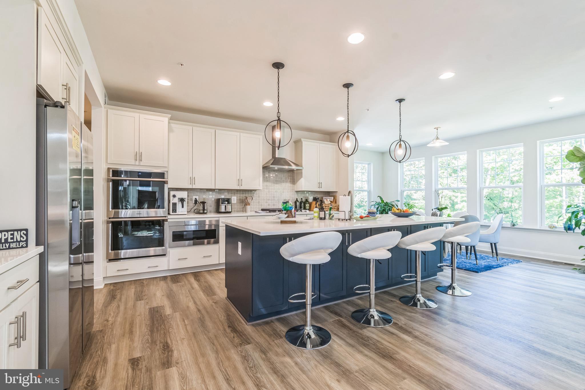 a large kitchen with a table and chairs
