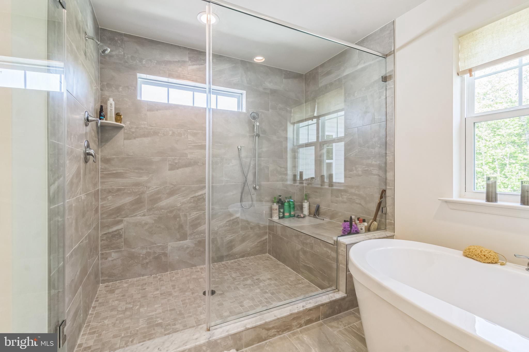 8604 Cedar Chase Drive Clinton, MD 20735 - Photo 30 of 68 a bathroom with a bathtub and a shower