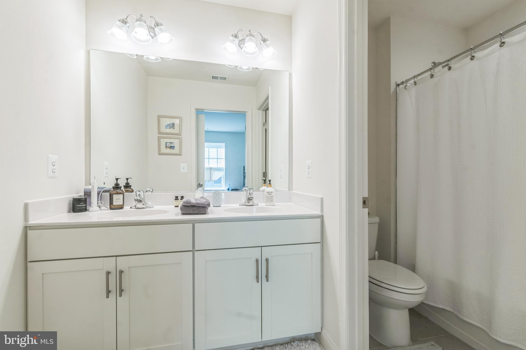 8604 Cedar Chase Drive Clinton, MD 20735 - Photo 34 of 68 a bathroom with a toilet sink and mirror