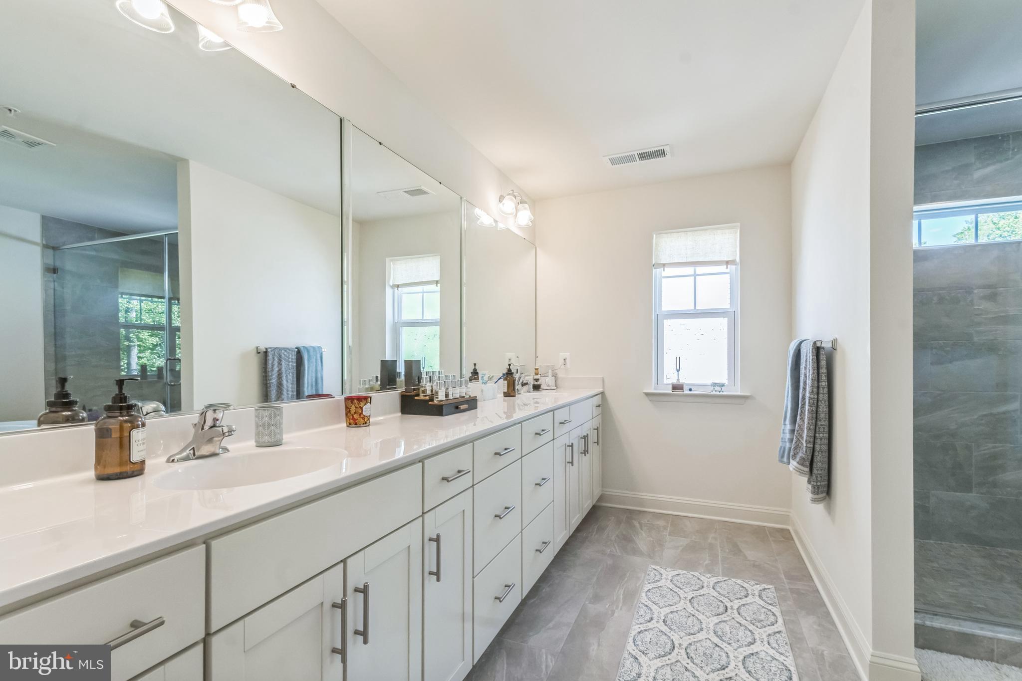 8604 Cedar Chase Drive Clinton, MD 20735 - Photo 48 of 68 a spacious bathroom with double sink and a mirror