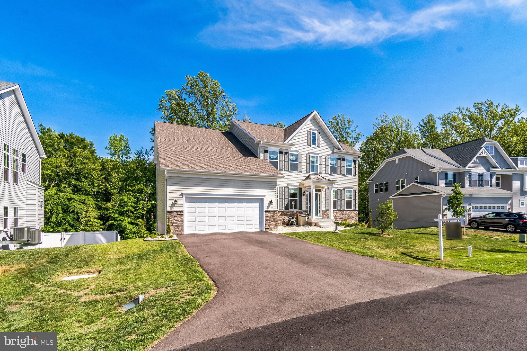 8604 Cedar Chase Drive Clinton, MD 20735 - Photo 5 of 68 a front view of a house with a yard and garage