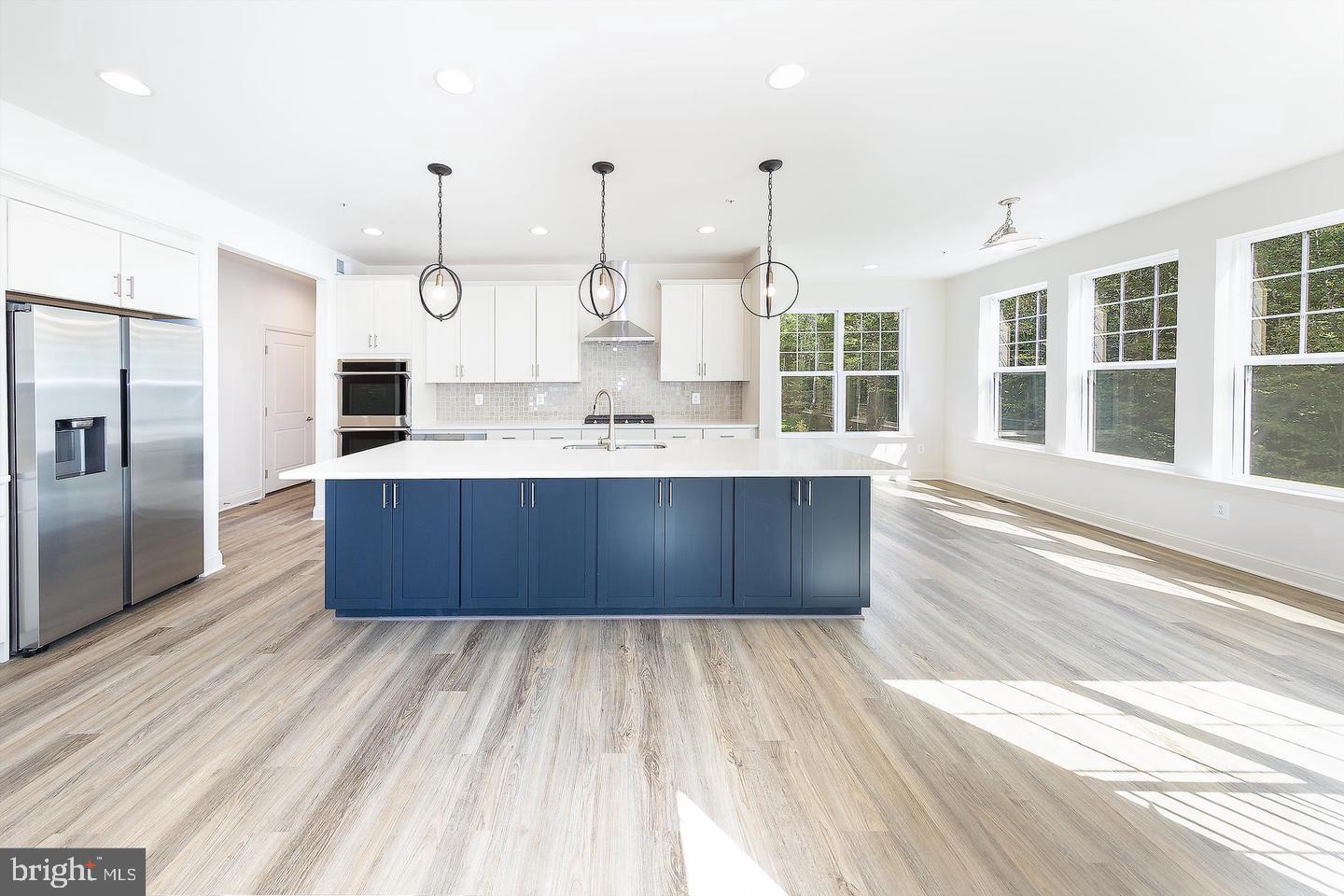 8604 Cedar Chase Drive Clinton, MD 20735 - Photo 58 of 68 a large kitchen with kitchen island a large counter top and stainless steel appliances