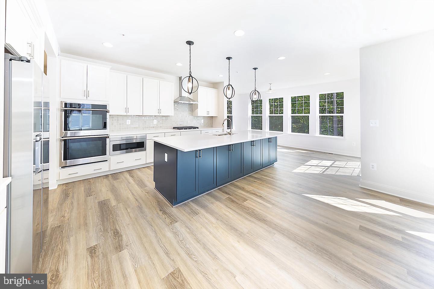 8604 Cedar Chase Drive Clinton, MD 20735 - Photo 59 of 68 a large kitchen with kitchen island a large counter top and stainless steel appliances