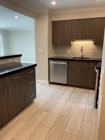 a kitchen with a sink and cabinets