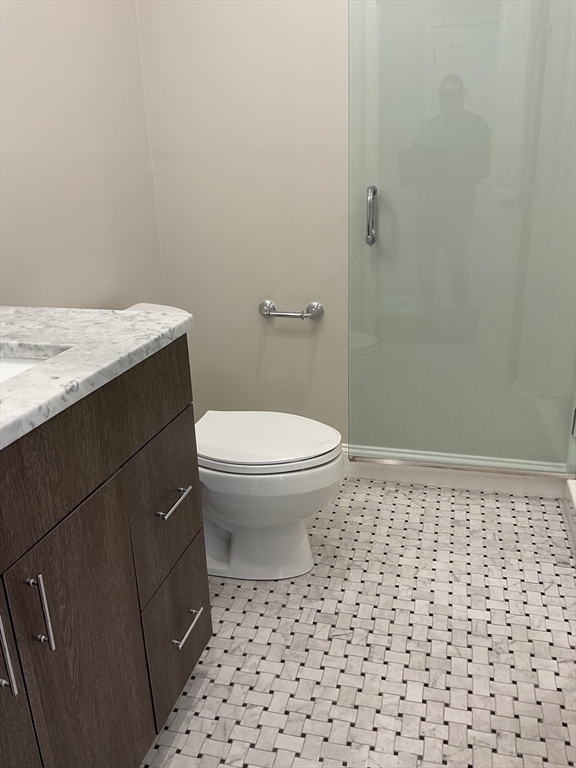 1006 Paradise Road, Unit PH Q Swampscott, MA 01907 - Photo 7 of 16 a bathroom with a sink a toilet and a shower