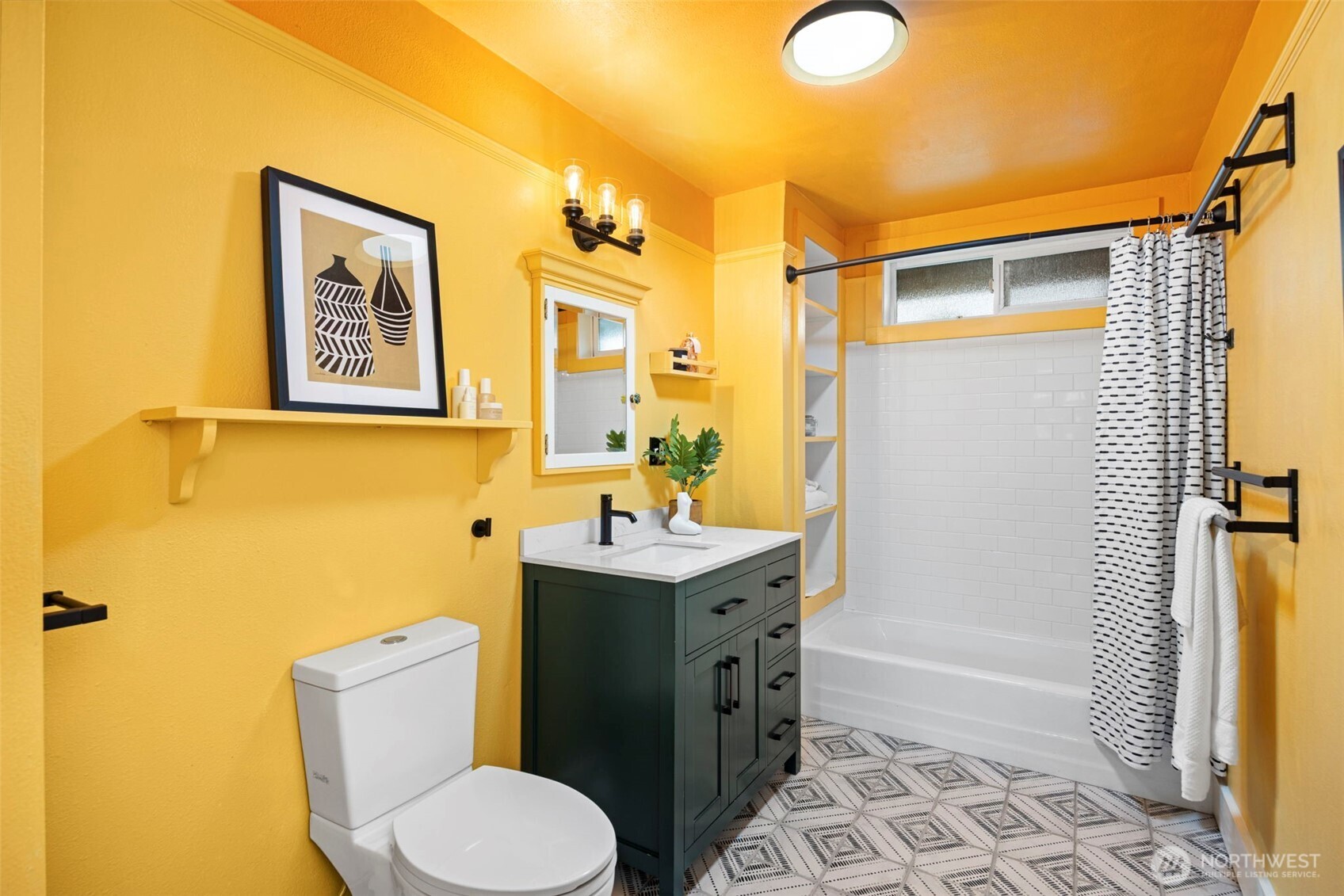 7813 46th Avenue South Seattle, WA 98118 - Photo 11 of 18 a bathroom with a toilet sink vanity tub and shower