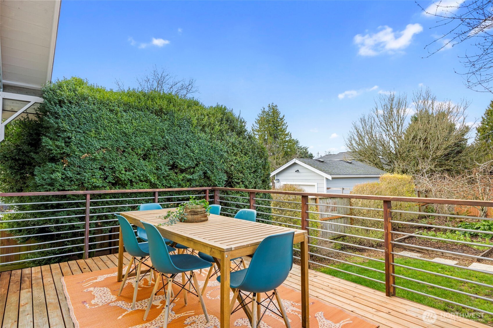 7813 46th Avenue South Seattle, WA 98118 - Photo 13 of 18 a view of a patio with couches table and chairs and potted plants with wooden floor and fence
