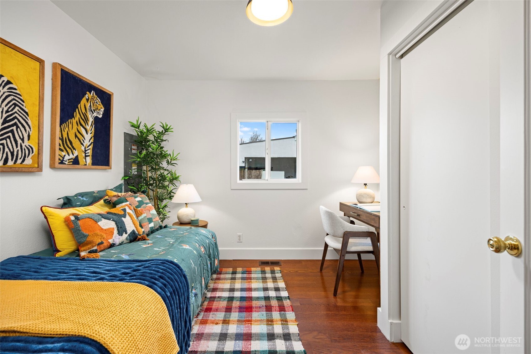 7813 46th Avenue South Seattle, WA 98118 - Photo 10 of 18 a bedroom with a bed and wooden floor